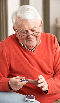 elderly man with diabetes blood test - forbes opticians, hadleigh, essex